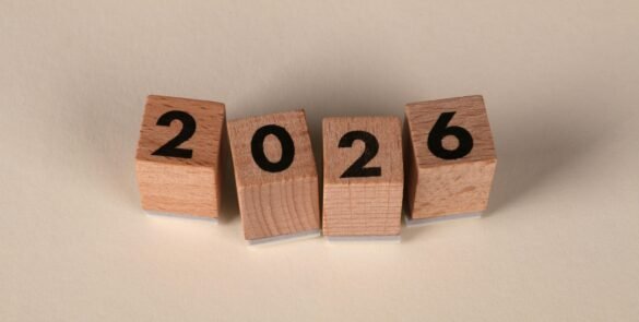 Wooden cubes forming the year 2026 on a neutral background.